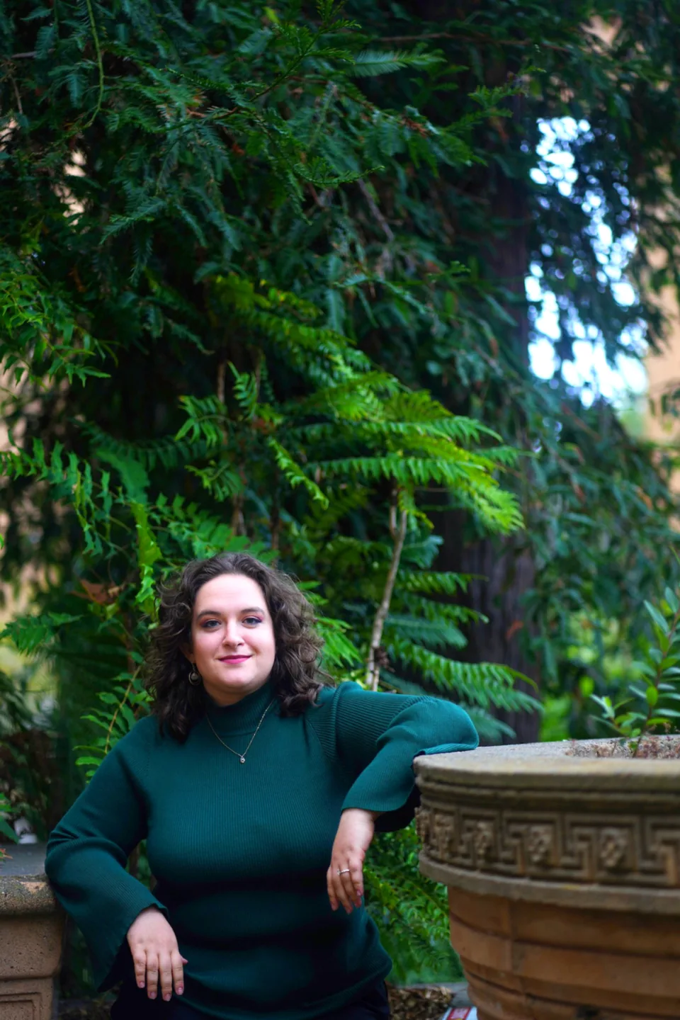 Leora Gilgur, voice teacher, standing among trees