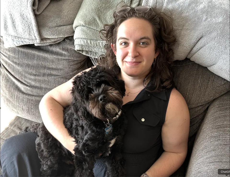Leora Gilgur relaxing on a couch with her dog