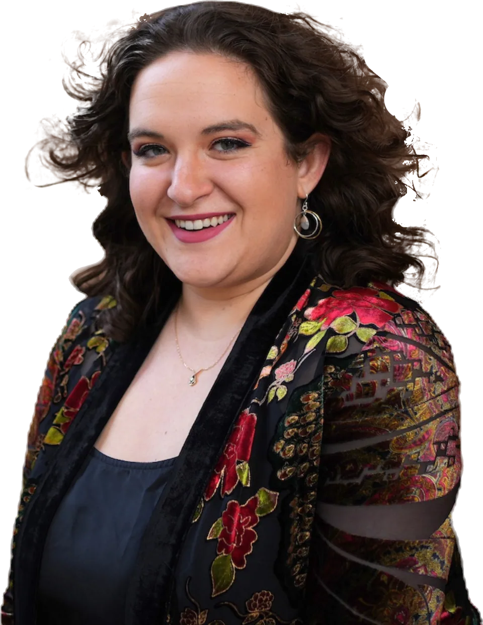 Leora Gilgur, mezzo-soprano and voice teacher, smiling in a floral jacket