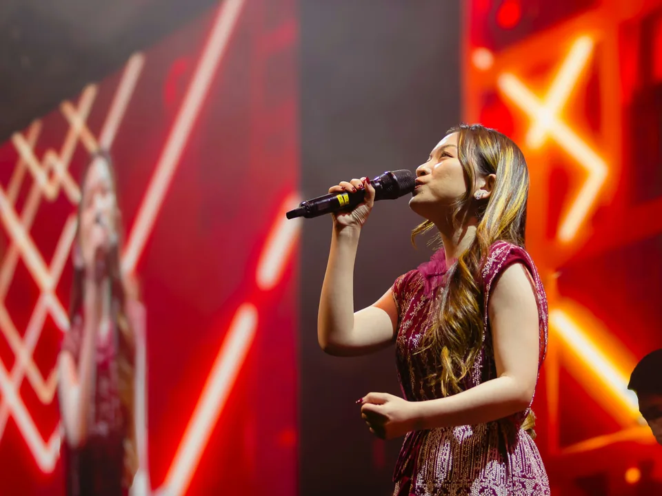 A professional vocalist performing on stage