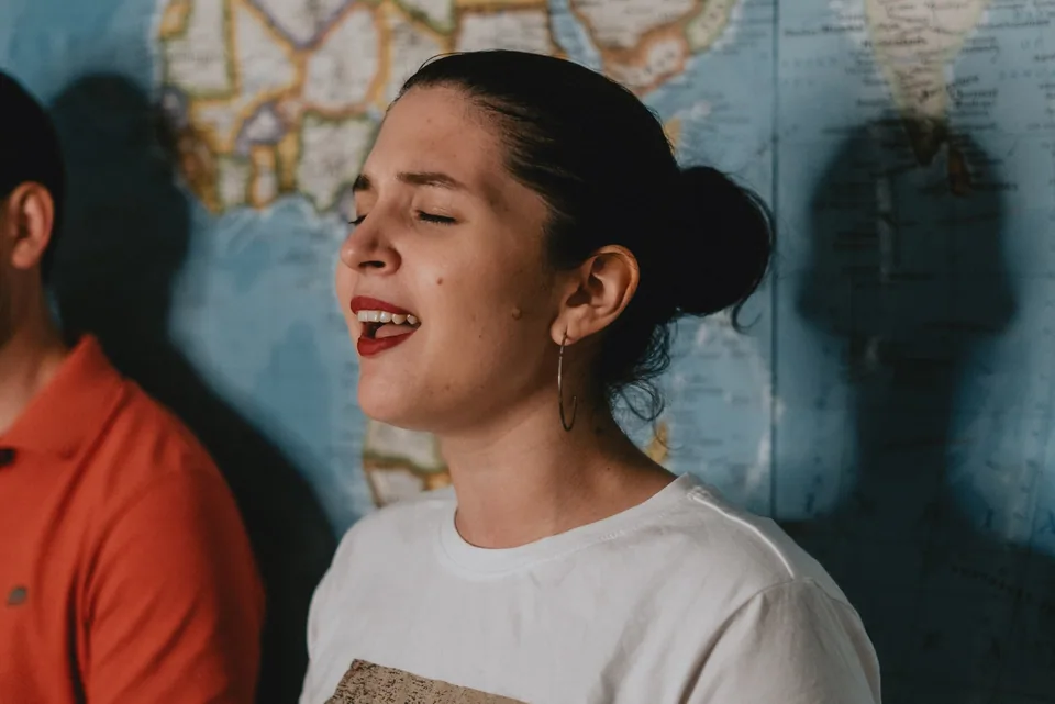 A singer mid-song, eyes closed