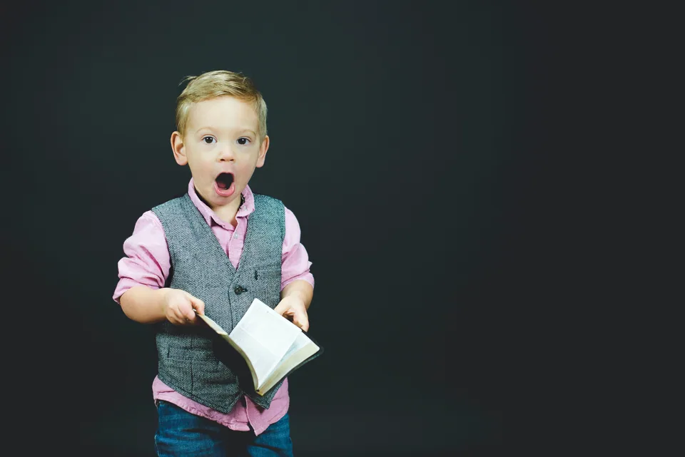 A young child singing with joy